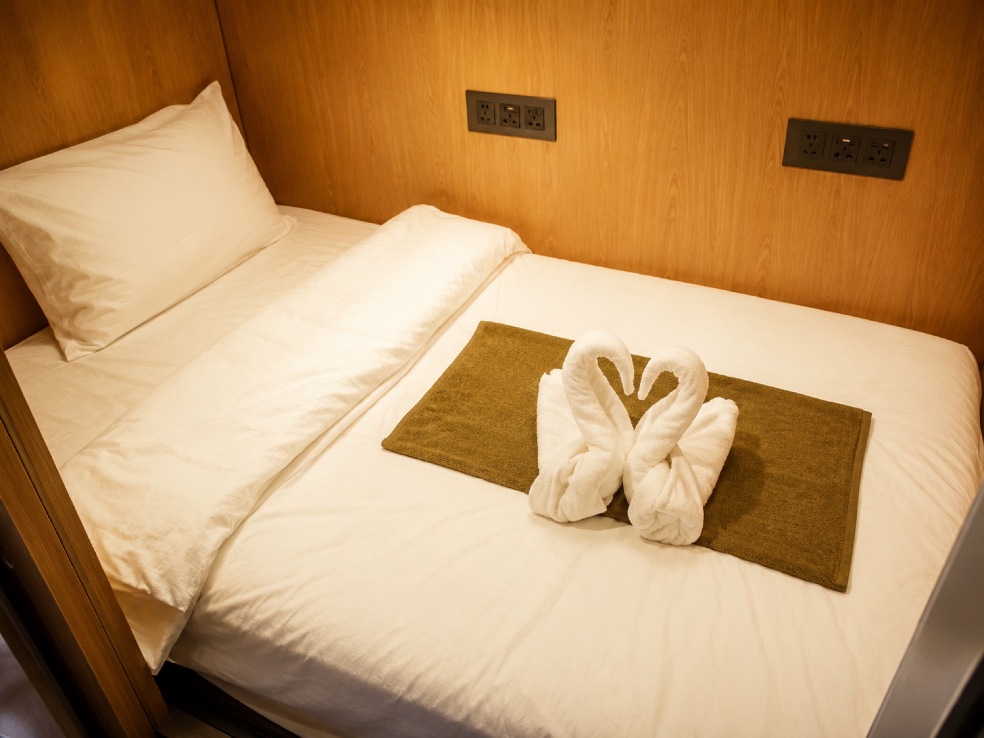 A made-up capsule with towels folded into swans